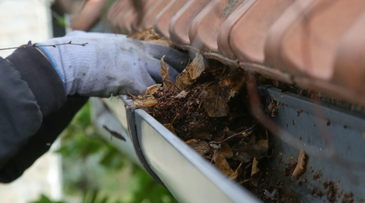 worker pressure washing patio tiles in Toronto backyard