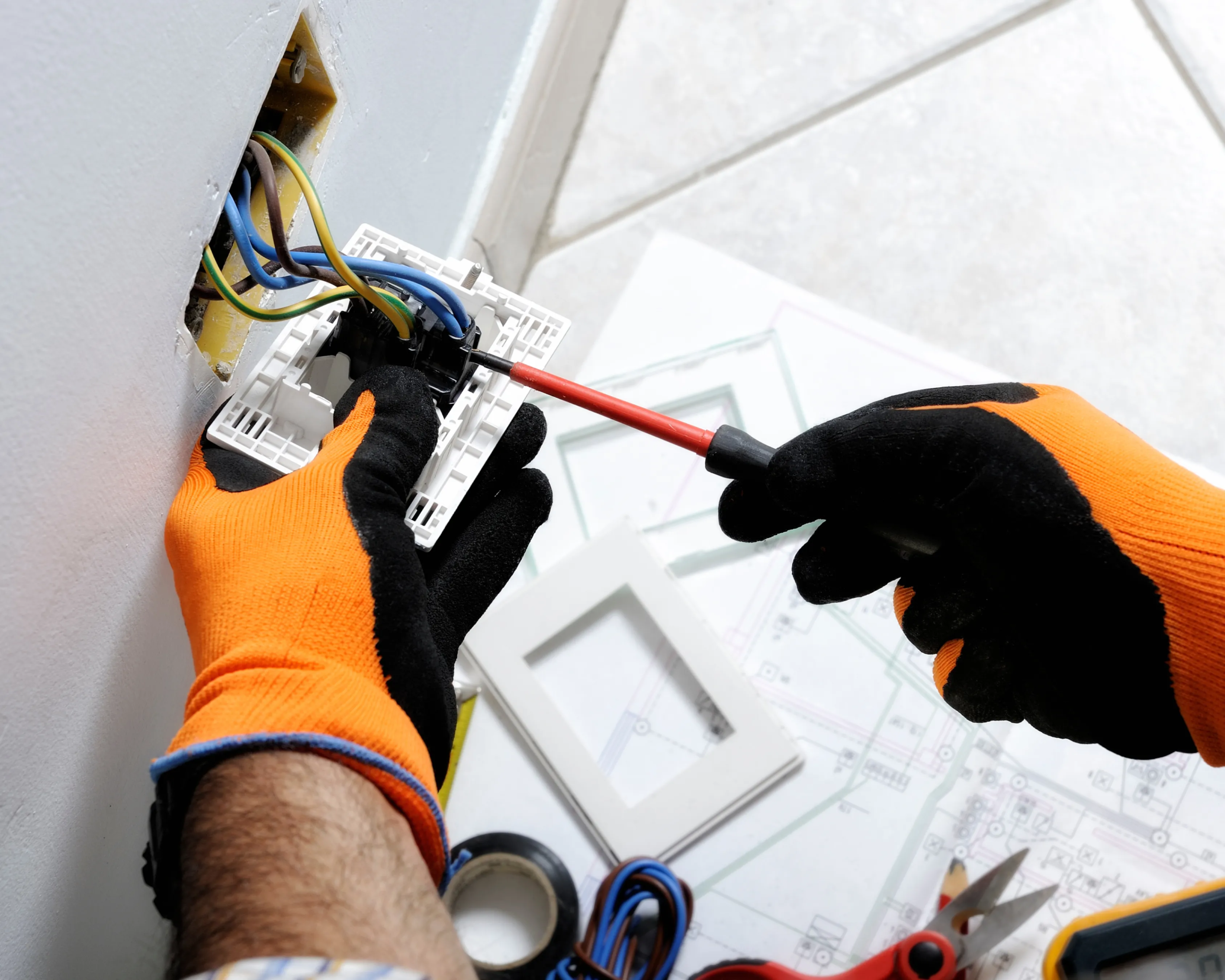 electrician fixing wall outlet in Toronto apartment