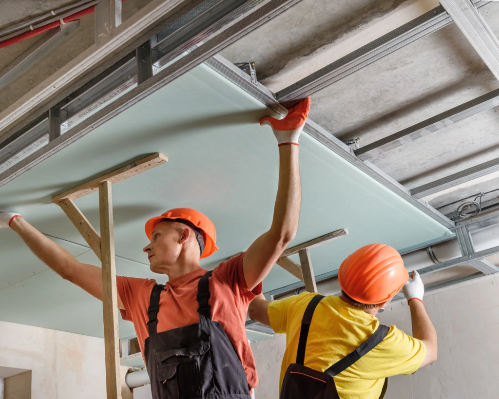 contractor installing false ceiling panels in Toronto apartment
