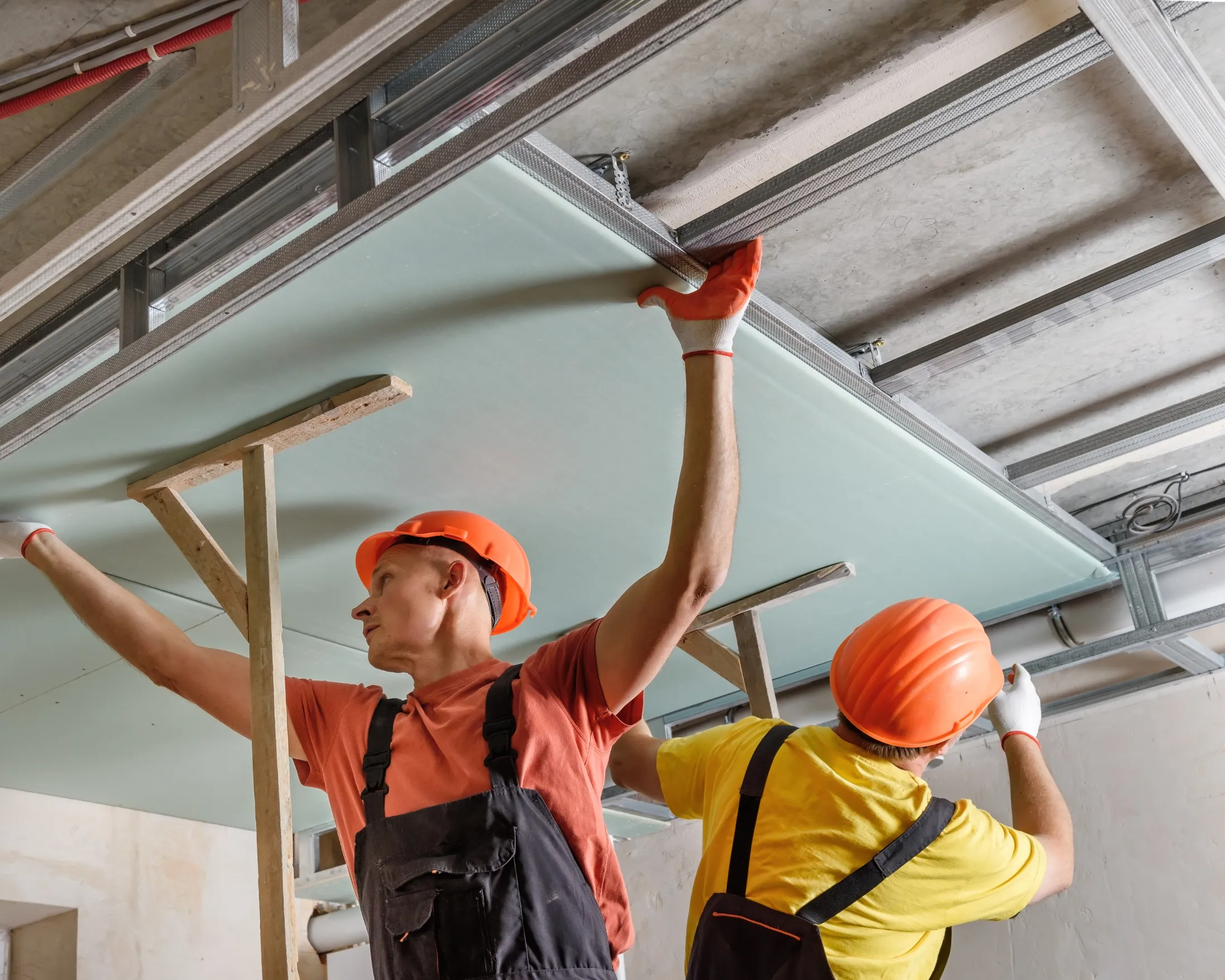 contractor installing false ceiling panels in Toronto apartment