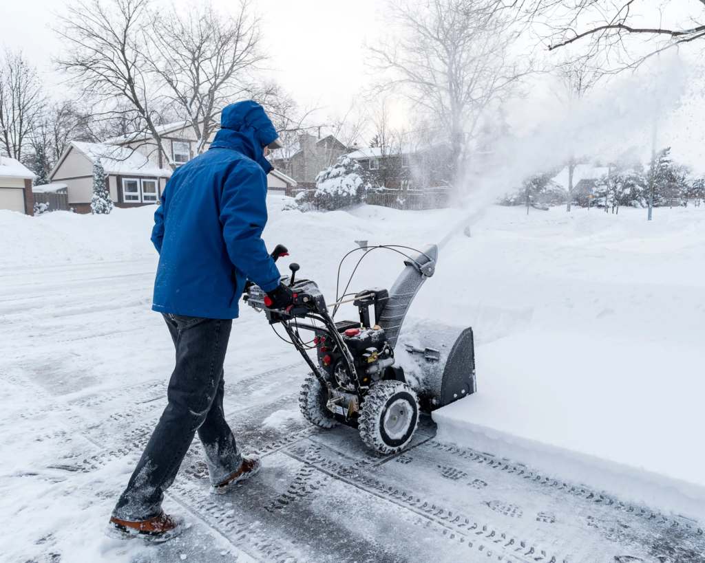 snow removal team clearing driveway in Toronto residential area