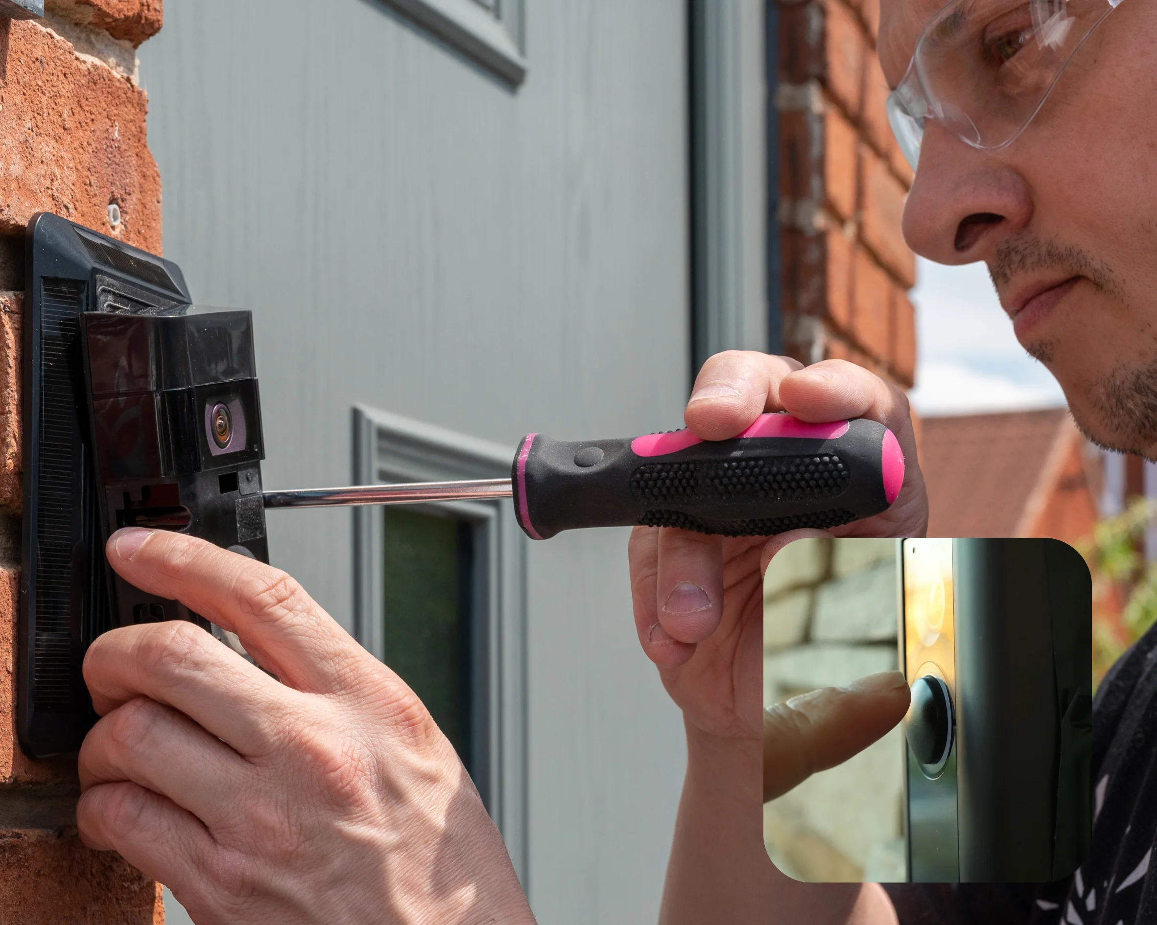 Technician installing a smart video doorbell next to a front door.