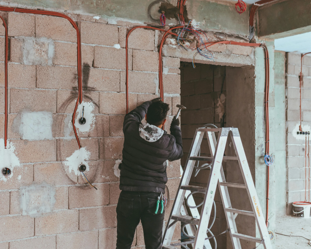 Electrician performing full home electrical wiring installation.