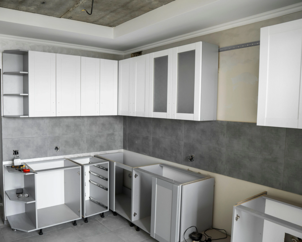 Technician installing new kitchen cabinets in a modern Toronto kitchen
