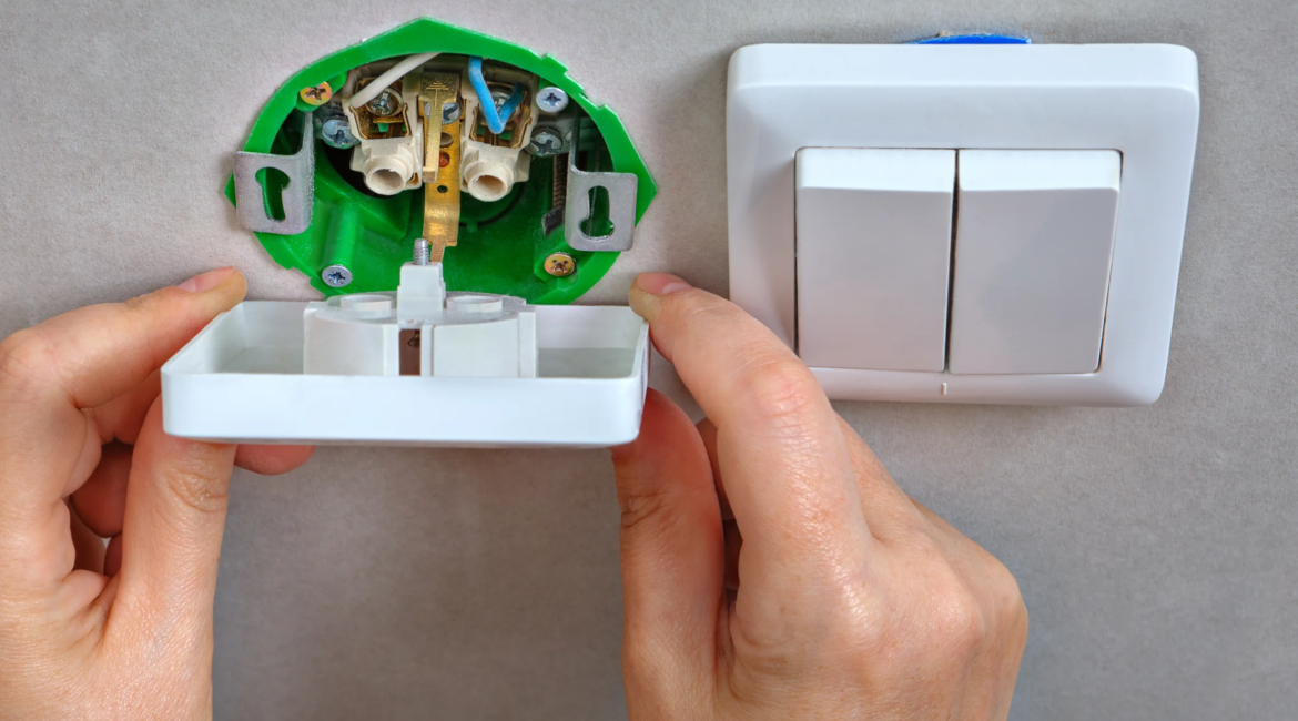 Electrician replacing a modern switch and USB outlet in a Toronto home.